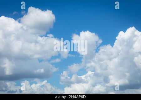Puffy white clouds against a blue sky Stock Photo