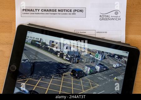 A Penalty Charge Notice for stopping in a box junction with camera evidence on ipad.  NB data anonymised. Stock Photo