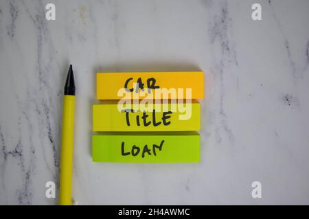 Car Title Loan write on sticky notes isolated on Wooden Table. Stock Photo