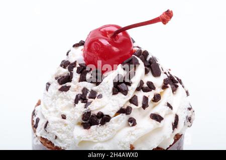 Black forest cake, topped with whipped cream and cherry isolated on white Stock Photo