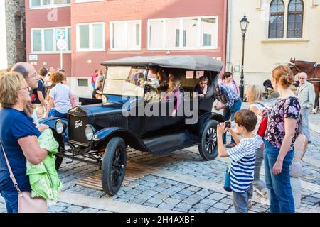 Black Ford model T with children on board, Kult100 event during the centenary year of Sopron plebiscite in 1921, in the inner city of Sopron, Hungary Stock Photo