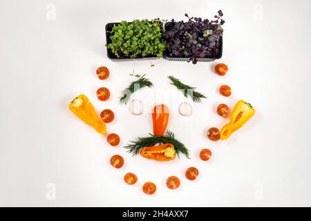 A person's face made of vegetables on a white background. Stock Photo