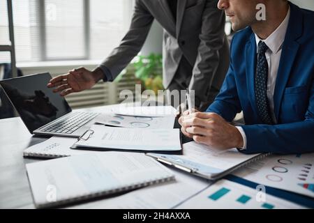 Cropped shot of two businessmen discussing project at table during meeting in office, copy space Stock Photo