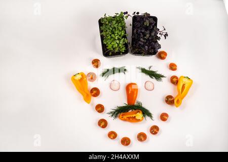 A person's face made of vegetables on a white background. Stock Photo