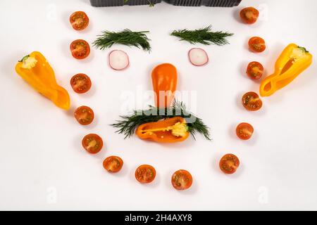 A person's face made of vegetables on a white background. Stock Photo