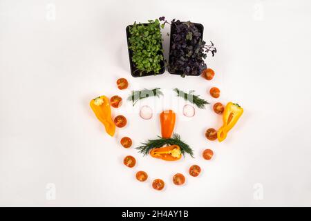 A person's face made of vegetables on a white background. Stock Photo