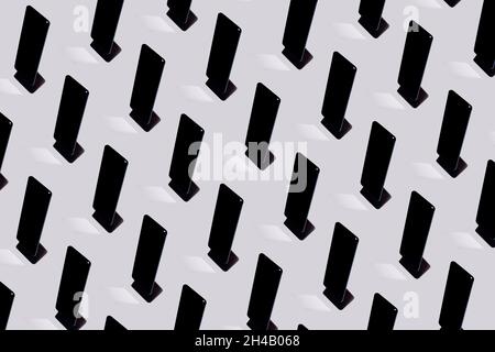 Floating mobile phone pattern on gray background. Creative top view layout with shadows and mirror. Technology idea. Communications concept. Stock Photo