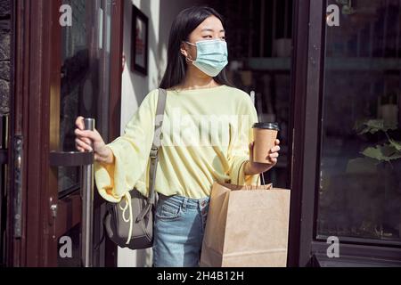 Photo of cheerful female leaving coffee shop Stock Photo