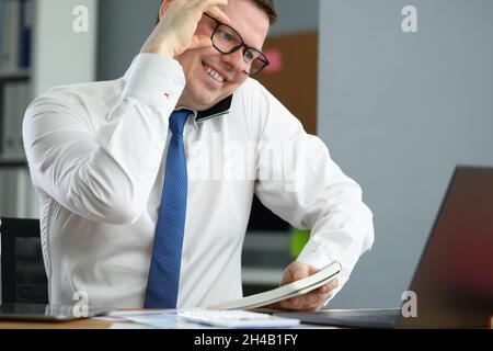Happy professional employee in cabinet Stock Photo