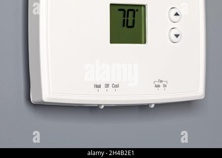 Thermostat for home furnace and air conditioner. Utility bill savings, energy cost and conservation concept Stock Photo