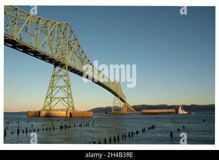 Astoria-Megler Bridge over Columbia River, Astoria, Oregon, with river barge going underneath, Bridge built in 1966 Stock Photo