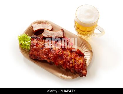 High angle shot of barbeque pork spareribs served with a glass of lager beer Stock Photo