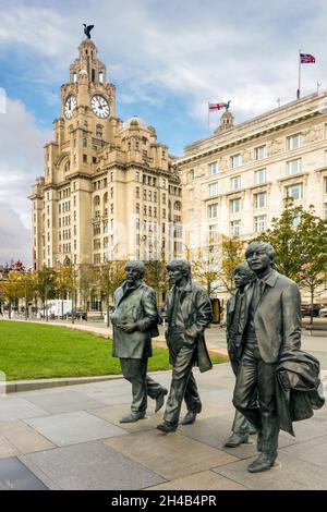 Bronze statues of the four Beatles created by sculptor Andy Edwards in front of the Liver buildings on the Liverpool pier head waterfront Stock Photo