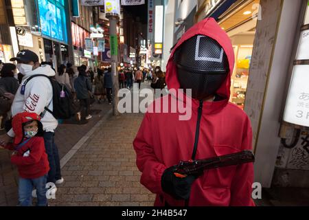 Tokyo, Japan. 30th Oct, 2021. A person seen wearing a squid game costume during Halloween celebrations in Shibuya.Tokyo's Shibuya ward governor requested that Halloween revelers to stay away from its famous scramble crossing again this year, as a measure to curb the spread of Coronavirus infections. Police and private security will patrol the area in a bid to prevent crowd trouble and alcohol sales have been discouraged in local stores and bars. (Photo by Damon Coulter/SOPA Images/Sipa USA) Credit: Sipa USA/Alamy Live News Stock Photo