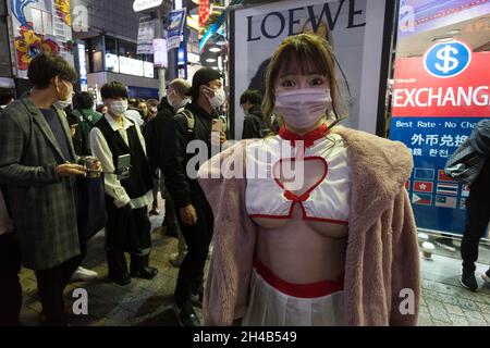 Tokyo, Japan. 30th Oct, 2021. A woman is seen wearing a revealing costume during Halloween celebrations in Shibuya.Tokyo's Shibuya ward governor requested that Halloween revelers to stay away from its famous scramble crossing again this year, as a measure to curb the spread of Coronavirus infections. Police and private security will patrol the area in a bid to prevent crowd trouble and alcohol sales have been discouraged in local stores and bars. (Photo by Damon Coulter/SOPA Images/Sipa USA) Credit: Sipa USA/Alamy Live News Stock Photo