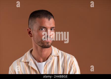 Studio portrait of a young man on a brown background Stock Photo