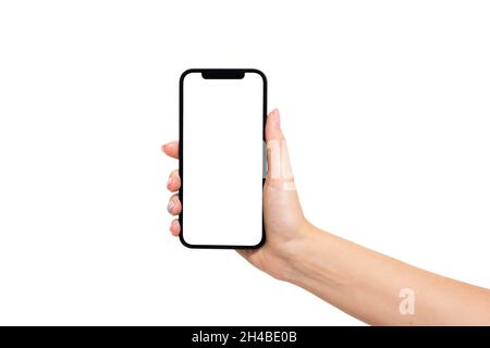 Woman hand holding smartphone with blank screen isolated on white background. Phone mockup Stock Photo