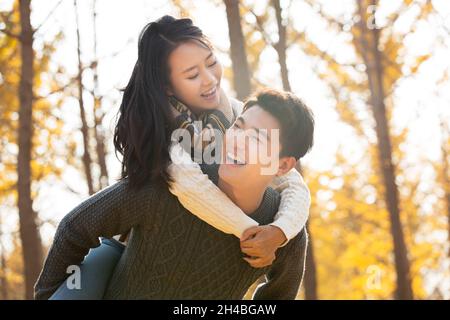 Young man carrying his girlfriend Stock Photo