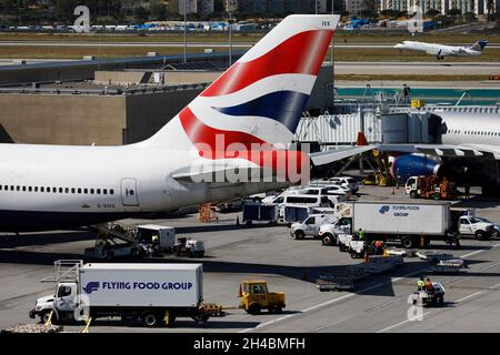 Los Angeles, California, USA. 28th Mar, 2019. Flying Food Group catering trucks drive past a British Airways Boeing Co. 747-400 (registration G-CIVX) at a gate at Los Angeles International Airport (LAX) on Thursday, March 28, 2019 in Los Angeles, Calif. © 2019 Patrick T. Fallon (Credit Image: © Patrick Fallon/ZUMA Press Wire) Stock Photo