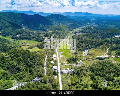 Aerial photography of magnificent scenery of blue sky and green mountains at Kunlun Pass in Nanning, Guangxi, China Stock Photo