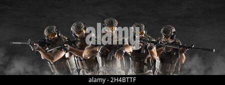 Group of professional special forces soldiers, during a special operation in smoke - photo format 3x1. Stock Photo