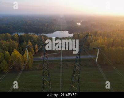 Support of a high-voltage power line with wires thrown across the river. Stock Photo
