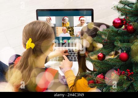 Virtual Christmas day house party. video conferencing Young man having video call via computer in the home office Online team gift opening conference Stock Photo