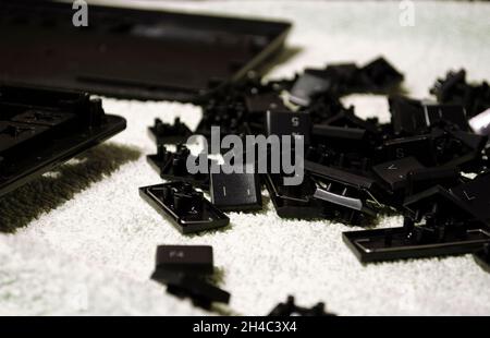 Disassembled keyboard. Keyboard parts close-up. Cleaning computer accessories. Stock Photo