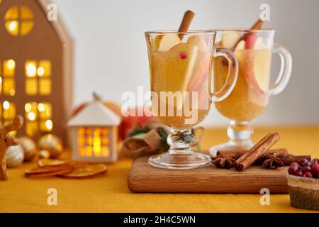 Two glasses of hot christmas winter apple gluhwein. Alcohol white mulled wine. Apple cider Stock Photo