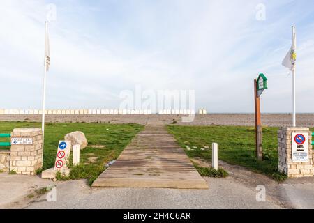 Gateway to the sea, on a pebble beach. Line of beach huts on the horizon. Cayeux-sur-Mer, Opal Coast, France Stock Photo