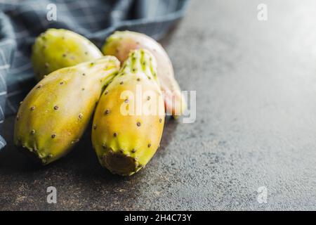 Raw prickly pears. Opuntia or indian fig cactus on kitchen table. Stock Photo