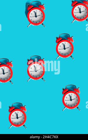 many red alarm clocks on blue background, pattern with hard light time concept, new year or christmas background. Winter holiday concept, flat lay, Te Stock Photo
