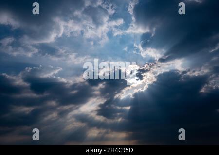 God light. Dark cloudy sky with sun beam. Sun rays through black clouds. God light from heaven for hope and faithful concept. Believe in god. Heaven Stock Photo