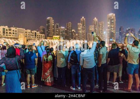 DUABI, UAE - MARCH 10, 2017: Crowds of people observe The Dubai Fountain. Stock Photo