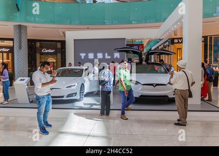 DUBAI, UAE - MARCH 12, 2017: Two Tesla cars exhibited in the Dubai Mall, one of the largest malls in the world. Stock Photo