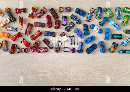 Top view random collection of model sport car toy hot wheels on wooden floor Stock Photo