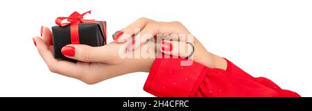 Womans hands with manicure holding gift on white background Stock Photo
