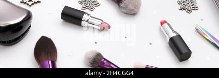 Women's accessories, cosmetics and makeup tools with Christmas decorations on a white background Stock Photo