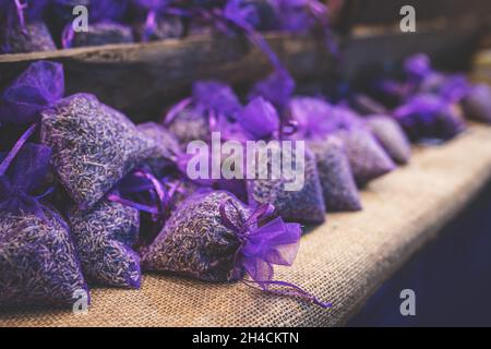 Lavender bud dry flower sachet fragrant bags, purple organza pouch with natural dried lavender flowers at market. Toned image with selective soft focus and copy space. Stock Photo