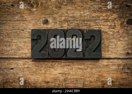 Year 2022 written with vintage letterpress printing blocks on rustic wooden background Stock Photo