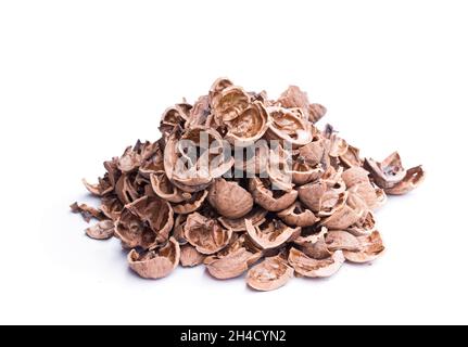 Pile  of empty broken walnut shells isolated on white Stock Photo
