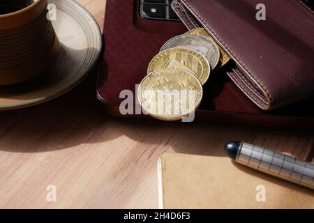 dhaka, bangladesh, 23th may 2021.golden bitcoins and wallet on laptop  Stock Photo