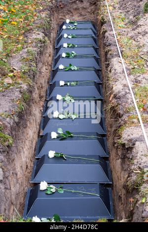 Dresden, Germany. 02nd Nov, 2021. Coffins lie in a grave during the reburial of war dead by the Voksbund Deutsche Kriegsgräberfürsorge. During construction work in Dresden's city center last year, the remains of most likely civilian war victims were found, which have now been given their final resting place in coffins at the war gravesite of the Johannis cemetery. Credit: Matthias Rietschel/dpa/Alamy Live News Stock Photo