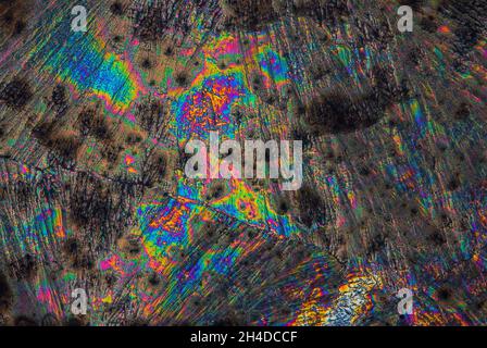 Extreme macro photograph of Vitamin C crystals forming abstract modern art patterns, when illuminated with polarized light, under a microscope Stock Photo