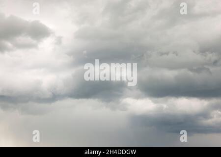 Overcast grey sky with dark clouds, background or template Stock Photo