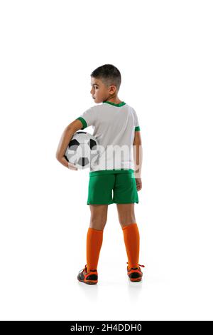 Full-length portrait of young boy, teenager, professional football player  in uniform with ball posing isolated over black background Stock Photo -  Alamy