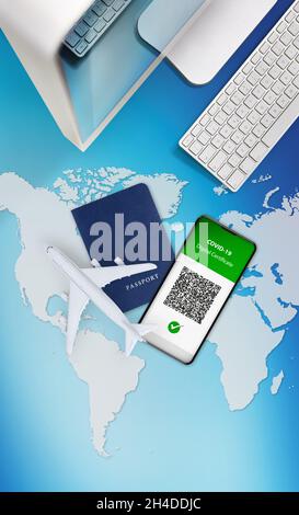 Green pass covid-19 vaccination concept for travel. Passport, airplane and computer isolated on blue background with geographic world map. Vaccine cer Stock Photo
