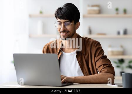 Happy middle eastern man employee working at office Stock Photo