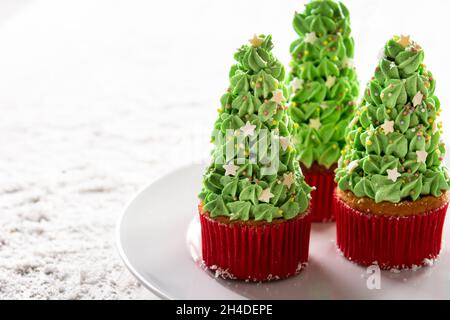 Christmas tree cupcakes on snow Stock Photo