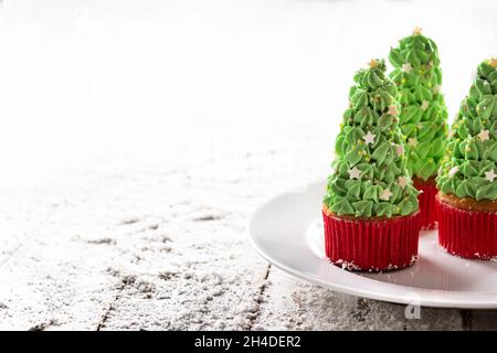 Christmas tree cupcakes on snow Stock Photo